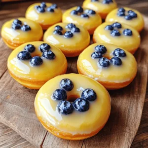 For my blueberry cake donuts, I use a simple list of ingredients. Here’s what you need: - 2 cups all-purpose flour - 1 cup granulated sugar - 2 teaspoons baking powder - 1/2 teaspoon baking soda - 1/2 teaspoon salt - 1/2 cup unsalted butter, melted - 1 cup buttermilk (or 1 cup milk + 1 tablespoon vinegar) - 2 large eggs - 1 teaspoon vanilla extract - 1 cup fresh blueberries (or frozen, if out of season) - Zest of 1 lemon - 1 cup powdered sugar (for glaze) - 2 tablespoons lemon juice (for glaze) These ingredients make the donuts soft and flavorful. The blueberries burst with sweetness. The lemon zest adds a nice pop of flavor that brightens the dish. I love using fresh blueberries when they are in season. If they are not, frozen ones work just fine. This recipe is easy to follow and fun to make. You can find the full recipe [here]. Now let’s get ready to bake! First, you need to heat your oven to 375°F (190°C). This helps the donuts rise well. Next, grease your donut pan with cooking spray or butter. This step stops the donuts from sticking. Make sure to cover every mold evenly. In a large bowl, mix the dry ingredients. Add 2 cups of all-purpose flour, 1 cup of granulated sugar, 2 teaspoons of baking powder, 1/2 teaspoon of baking soda, and 1/2 teaspoon of salt. Use a whisk to blend everything well. This mix gives your donuts their rise and flavor. In another bowl, combine your wet ingredients. Start with 1/2 cup of melted unsalted butter. Then add 1 cup of buttermilk, 2 large eggs, 1 teaspoon of vanilla extract, and the zest of 1 lemon. Mix until it looks smooth. This mixture brings moisture and richness to the donuts. Now, slowly add the wet mix to the dry ingredients. Stir gently until just combined. Be careful not to overmix, as this can make the donuts tough. A few lumps are okay; they will bake out. Take a piping bag or a spoon. Use it to fill each donut mold about 2/3 full with the batter. This gives them room to rise. Try to distribute the batter evenly for uniform donuts. Place your filled donut pan in the oven. Bake for 10-12 minutes. Check if they are done by gently pressing the tops. They should bounce back. You can also insert a toothpick; it should come out clean. While the donuts bake, make the glaze. In a small bowl, mix 1 cup of powdered sugar with 2 tablespoons of lemon juice. Stir well until it’s smooth. If it’s too thick, add more lemon juice. If it’s too thin, add more powdered sugar. Once the donuts cool for about 5 minutes, take them out of the pan. Place them on a wire rack to cool completely. When they are cool, dip the tops in the glaze. Let the glaze set for a few minutes. Now, enjoy your delicious blueberry cake donuts! For the full recipe, refer to the section above. To get soft and fluffy donuts, use room temperature ingredients. Cold butter or eggs can make the batter dense. Always mix the wet and dry ingredients separately first. Then, combine them gently. Overmixing can lead to tough donuts. The batter should be thick but not dry. Also, let the batter sit for a few minutes before baking. This helps the flavors blend well. Blueberries can sink to the bottom if not handled right. To prevent this, toss the blueberries in a little flour before adding them to the batter. This helps them stay suspended. Fold them in gently with a spatula. You want to keep them whole for best flavor. Spread the blueberries evenly throughout the batter for a tasty bite every time. For a shiny glaze, mix powdered sugar with lemon juice. Start with a little juice and add more for the right thickness. Dip the tops of each donut in the glaze when they are cool. This keeps the glaze from melting. Let the glaze set for a few minutes on a wire rack. If you want a thicker glaze, use more sugar. For a fun twist, add a dash of vanilla extract to the glaze for extra flavor. For the complete preparation steps, check out the Full Recipe. {{image_2}} You can swap blueberries for other fruits. Raspberries and strawberries work well. You can also try adding bananas for a sweet twist. Just remember to adjust the amount based on the fruit's moisture. This keeps your donuts from getting too soggy. Want to make these donuts gluten-free? Use a 1:1 gluten-free flour blend. Brands like Bob's Red Mill or King Arthur Flour are great choices. These blends have the right mix of flours and starches. You can also add a bit of xanthan gum if your blend doesn’t include it. This helps give the donuts their nice texture. Mix in some chocolate chips with your blueberries. Dark chocolate pairs well with the fruity flavor. Use about half a cup of chocolate chips for a sweet surprise. This twist makes the donuts rich and extra fun. The chocolate melts just right during baking, giving each bite a tasty treat. Get creative with these ideas, and enjoy making your Blueberry Cake Donuts! For the full recipe, check out the detailed instructions above. To keep your blueberry cake donuts fresh, store them in an airtight container. Place parchment paper between layers to prevent sticking. Store at room temperature for up to two days. If you want to keep them longer, consider freezing. Freezing is a great option for long-term storage. First, let the donuts cool completely. Wrap each donut in plastic wrap. Then, place them in a freezer bag or container. They can last up to three months in the freezer. When you're ready to enjoy, just thaw them overnight in the fridge. To bring back the fresh taste, reheat the donuts in the oven. Preheat it to 350°F (175°C). Place the donuts on a baking sheet and warm them for about 5-7 minutes. This will help them regain their soft texture. If you prefer, you can microwave them for 10-15 seconds, but they may become a bit chewy. Enjoy your delightful treats! Yes, you can use frozen blueberries. They work well in this recipe. Just remember to thaw them first. This helps the batter stay smooth. If you add frozen blueberries directly, they might make the batter too wet. Thawed blueberries also stay juicy in the donut. You can tell the donuts are done when they spring back. Gently press the top with your finger. If it bounces back, it's ready! You can also use a toothpick. Insert it into the donut, and if it comes out clean, they are done. If you don’t have buttermilk, you can make your own. Mix 1 cup of milk with 1 tablespoon of vinegar. Let it sit for a few minutes. This mixture will give you a similar tangy flavor. You can also use plain yogurt or sour cream as a substitute. These donuts stay fresh for about 2 days at room temperature. Store them in an airtight container. If you want them to last longer, keep them in the fridge for up to a week. You can even freeze them for up to 3 months! Just remember to wrap them well. You now have a great blueberry donut recipe. Remember the key steps: mix dry and wet ingredients, fill molds, and bake. Use tips for texture and glaze for best results. Feel free to try other fruits or gluten-free options. Store leftovers properly to keep them fresh. Enjoy your baking journey and the delicious donuts you create!