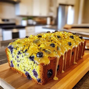 - Grated Zucchini: Use 1 ½ cups, which is about 1 medium zucchini. Make sure to squeeze out excess water after grating. This keeps the bread from being too wet. - Fresh Blueberries: Use 1 cup of fresh blueberries for the best taste. You can substitute with frozen blueberries if fresh aren’t available. - Flour Types: Combine 1 cup of all-purpose flour with ½ cup of whole wheat flour. This mix adds flavor and texture. - Sugars: Use ½ cup of granulated sugar and ¼ cup of packed brown sugar. The brown sugar adds moisture and a slight caramel flavor. - Baking essentials: Include ½ teaspoon of baking soda, 1 teaspoon of baking powder, and ½ teaspoon of salt. These help the bread rise and balance flavors. - Flavor boosters: Add 1 teaspoon of ground cinnamon, 1 teaspoon of vanilla extract, the zest of 1 lemon, and 1 tablespoon of lemon juice. These ingredients bring a bright, fresh flavor. - Powdered sugar: You need ½ cup of powdered sugar for the glaze. This gives it a sweet and smooth finish. - Lemon juice for the glaze: Use 1 tablespoon of lemon juice to mix with the powdered sugar. This will create a tangy glaze that complements the bread perfectly. For the full recipe, you can follow the steps I laid out earlier. Enjoy baking this delightful treat! Start your journey by preheating your oven to 350°F (175°C). This ensures a perfect bake. Grease a 9x5-inch loaf pan or line it with parchment paper. This keeps the bread from sticking. Next, grab a large bowl. Combine the grated zucchini, sugars, vegetable oil, eggs, vanilla, lemon zest, and lemon juice. Mix everything well. You want a smooth blend that brings out the flavors. In another bowl, whisk together the all-purpose flour, whole wheat flour, baking soda, baking powder, salt, and ground cinnamon. This step is crucial for an even rise. To avoid lumps, make sure to whisk thoroughly. If you find some lumps, push them against the side of the bowl. They will break apart easily, ensuring a smooth batter. Now, gently fold in the fresh blueberries. Be careful not to crush them; we want whole berries in your bread. This adds bursts of flavor in every bite. Once the blueberries are mixed in, pour the batter into your prepared loaf pan. Use a spatula to smooth the top. This will help it bake evenly. For the full recipe, check out the instructions above for more details. To make great zucchini bread, you must not overmix the batter. Overmixing can cause your bread to be tough. It is best to mix until just combined. Some lumps are fine. Using room temperature ingredients helps the batter mix smoothly. Take the eggs and oil out of the fridge before you start. This small step makes a big difference. Fresh ingredients always taste better than dried ones. Use fresh blueberries for a juicy burst of flavor. They brighten up every slice. If you only have frozen blueberries, they will work too. Just be careful not to overmix them into the batter. You can boost the lemon flavor by adding more lemon zest. This gives your bread a bright taste. You might also try a little extra lemon juice. Just a teaspoon can make a tasty change. Baking time is key. The bread needs about 50 to 60 minutes in the oven. Use a toothpick to check for doneness. If it comes out clean, your bread is ready! If the top of your bread browns too fast, cover it loosely with foil. This will help it bake evenly without burning. {{image_2}} You can change the fruits or nuts in this recipe. Try using raspberries instead of blueberries. Chopped walnuts or pecans can add a nice crunch. For a gluten-free option, you can use almond flour or a gluten-free flour mix. Just make sure to adjust the liquid slightly. Adding spices can kick up the flavor. Consider adding nutmeg or cardamom for warmth. You can also add more lemon zest for extra citrus. If you love chocolate, fold in some mini chocolate chips. Vanilla extract can enhance the sweet notes in the bread too. This bread works great for breakfast or dessert. Serve it warm with butter or jam. For a fun twist, you can toast slices and top them with whipped cream and berries. Drizzling the glaze over each slice adds a lovely finish. You can even serve it with a scoop of ice cream for a tasty treat. Enjoy! You can keep your glazed lemon blueberry zucchini bread at room temperature for about 2 days. Store it in a cool, dry place. Wrap it in plastic wrap or place it in an airtight container. This keeps it fresh and moist. If you want to store it longer, put it in the fridge. This bread lasts about 1 week when refrigerated. Make sure to wrap it well in plastic wrap or foil to avoid drying out. To freeze your zucchini bread, wrap it tightly in plastic wrap and then in aluminum foil. This helps prevent freezer burn. You can freeze it for up to 3 months. When ready to enjoy, thaw it in the fridge overnight. This keeps the taste and texture just right. For the best results, heat it in the oven for a few minutes before serving. Yes, you can use frozen blueberries in this recipe. They work well and save time. However, they may change the texture a bit. Frozen blueberries can make the batter wetter. This can lead to a denser loaf. To reduce this, you can slightly thaw them and drain excess juice before adding. To make this recipe vegan, you can substitute the eggs with flax eggs or applesauce. For each egg, mix 1 tablespoon of flaxseed meal with 2.5 tablespoons of water. Let it sit for five minutes to thicken. Use plant-based milk or yogurt instead of dairy. These swaps keep the bread moist and delicious. If your zucchini bread is dense, a few things might be wrong. Overmixing can make the bread tough. Another issue could be too much moisture from the zucchini. Make sure to squeeze out excess water before adding it to the batter. Lastly, check your baking powder and baking soda for freshness. Yes, you can make mini loaves with this recipe! Use mini loaf pans instead of a standard loaf pan. Bake at the same temperature but reduce the time to 25-30 minutes. Check for doneness by inserting a toothpick. This gives you cute, portable treats perfect for sharing! This blog post shared everything you need to make delicious zucchini bread. We covered key ingredients, tips for the best flavor, and step-by-step instructions. You learned how to store your bread and even explored variations to match your taste. Remember, baking is fun, so don’t hesitate to experiment. Enjoy making this delightful treat, and share it with others. Your zucchini bread journey starts now!