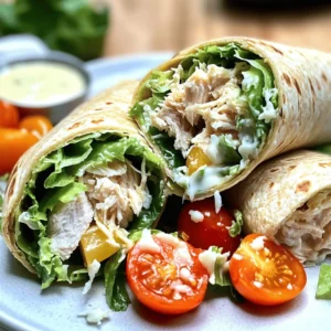 - 2 cups cooked chicken breast, shredded - 1 cup romaine lettuce, chopped - ½ cup cherry tomatoes, halved - ¼ cup grated Parmesan cheese - ¼ cup Caesar dressing - 4 large whole wheat tortillas - 1 teaspoon garlic powder - Salt and pepper to taste - Optional: Croutons for added crunch The Chicken Caesar Wrap is both tasty and easy to make. You start with some main ingredients. Use two cups of cooked chicken breast that you shred into bite-sized pieces. This chicken gives the wrap its protein kick. Next, add one cup of chopped romaine lettuce for crunch. The lettuce keeps the wrap fresh and light. Then, we have half a cup of halved cherry tomatoes. They add a burst of flavor and color. Don’t forget the cheese! A quarter cup of grated Parmesan cheese gives the wrap a creamy touch. Finally, drizzle in a quarter cup of Caesar dressing. This dressing ties all the flavors together. For some extra fun, you can use optional ingredients. Four large whole wheat tortillas hold everything together. You could sprinkle in a teaspoon of garlic powder for more flavor. A little salt and pepper can round out the taste. If you want more crunch, toss in some croutons. This recipe is simple and flexible. You can adjust it to suit your taste. For the full recipe, check the details above! Start by gathering all your ingredients. In a large bowl, combine these items: - 2 cups cooked chicken breast, shredded - 1 cup romaine lettuce, chopped - ½ cup cherry tomatoes, halved - ¼ cup grated Parmesan cheese Mix them well to ensure even distribution. This mix is important for flavor in your wrap. Now, it’s time to add flavor. Pour in: - ¼ cup Caesar dressing - 1 teaspoon garlic powder - Salt and pepper to taste Toss the mixture thoroughly. You want every piece to be coated in Caesar dressing. This step makes each bite tasty. Grab a large whole wheat tortilla. Spoon an even amount of the chicken Caesar mixture onto the center. If you like a crunch, add croutons now. Fold the sides of the tortilla inward. Then roll it from the bottom up. Keep it tight to hold all the fillings. Repeat this for the remaining tortillas. For an extra touch, grill the wraps for 2-3 minutes on each side. This step adds a nice crispness and enhances the flavors. Enjoy your Chicken Caesar Wrap! For a full recipe, check the details above. To make your Chicken Caesar Wrap pop, cut each wrap in half. This shows off the colorful filling. Place the halves on a nice platter. You can sprinkle extra Parmesan cheese on top for flair. A small bowl of Caesar dressing makes a great dip. For sides, try fresh fruit, chips, or a simple salad. These add color and flavor to your meal. You can also serve it with a light soup for a cozy touch. Feel free to switch up the protein! You can use grilled shrimp, turkey, or even chickpeas. Each option gives a new taste. Not a fan of Caesar dressing? Try ranch, blue cheese, or a yogurt-based option. All can add a unique twist. Use seasonal veggies to enhance your wraps. In spring, add asparagus or snap peas. In summer, try bell peppers or zucchini. These will keep your meal fresh and exciting. For the full recipe, check the earlier section! {{image_2}} You can easily make this wrap vegetarian. Simply replace chicken with chickpeas or tofu. Both options add protein and texture. - Chickpeas: Use one can of drained and rinsed chickpeas. Mash them slightly for better mixing. - Tofu: Cube firm tofu and sauté it until golden. This gives a nice flavor and texture. Also, switch to a plant-based Caesar dressing. Look for brands that use vegan ingredients. This keeps your wrap tasty and meat-free. If you need a gluten-free option, there are great alternatives. Try using gluten-free tortillas. These are often made from rice or corn. - Alternative wraps: Many stores have gluten-free options. Check for wraps made from brown rice or chickpeas. Another way is to serve the wrap's components separately. This way, you can make a salad version. Just arrange the chicken, lettuce, tomatoes, and dressing in a bowl. This keeps the meal gluten-free and just as delicious. These variations let you enjoy the Chicken Caesar Wrap while catering to different diets. You can find the full recipe above to guide you! To store your Chicken Caesar wraps, wrap them tightly in plastic wrap or foil. This keeps them fresh and prevents them from drying out. You can also place them in airtight containers. A good choice is a container with a lid that seals tightly. This way, the flavors stay intact. Make sure to label your containers with the date. This helps you track how long they have been stored. Chicken Caesar wraps can last in the fridge for about 3 to 4 days. When it's time to enjoy your leftovers, you want them warm but not soggy. The best way to reheat wraps is in a skillet. Heat the skillet over medium heat. Place the wrap in the skillet and cover it with a lid. This keeps the heat in and warms the inside. Cook for about 3 to 5 minutes on each side. Flip it carefully to avoid spilling the filling. If you prefer, you can use an oven. Preheat it to 350°F (175°C). Wrap the chicken Caesar in foil and heat for about 10 minutes. This method keeps the wrap crispy on the outside while warming the inside. Enjoy your meal! Chicken Caesar wraps stay fresh in the fridge for about three days. To keep them safe, store them in an airtight container. If you see any signs of spoilage, throw them away. Always check for a bad smell or any change in color before eating. Yes, you can make Chicken Caesar wraps ahead of time. To keep them fresh, wrap them tightly in plastic wrap or foil. Place them in the fridge until you are ready to eat. If you want the wraps to stay crisp, wait to add the dressing until just before serving. You can serve many tasty sides with Chicken Caesar wraps. Here are a few ideas: - A simple side salad with mixed greens - Crispy baked sweet potato fries - Fresh fruit salad for a sweet touch - Veggie sticks with hummus for crunch - A cup of soup, like tomato or minestrone These sides will balance out your meal and add flavor. Enjoy exploring the options! For the full recipe, check out the Zesty Chicken Caesar Wrap section above. In this blog post, we explored how to make tasty Chicken Caesar wraps. We looked at main and optional ingredients, plus step-by-step instructions for preparing, mixing, and assembling. I shared tips for serving and customizing your wraps, along with variations for vegetarians and gluten-free options. We also talked about the best ways to store and reheat leftovers. Now you can enjoy this quick meal with ease. Happy cooking!