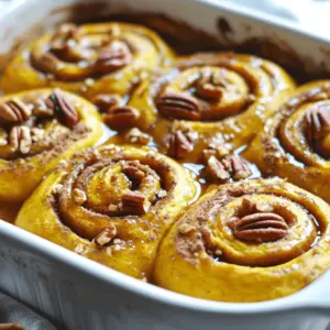 - 2 cups canned pumpkin puree - 1/2 cup brown sugar, packed - 2 teaspoons ground cinnamon - 1 teaspoon ground nutmeg - 1/2 teaspoon ground ginger - 1/4 teaspoon salt - 3 large eggs - 1/2 cup milk (or plant-based milk) - 1 teaspoon vanilla extract - 2 cans refrigerated cinnamon roll dough - 1/2 cup pecans, chopped (optional) - 1/2 cup maple syrup (for drizzling) These ingredients create a warm and cozy dish. The pumpkin puree gives a rich flavor. The brown sugar adds sweetness, while spices like cinnamon and nutmeg bring warmth. Using eggs and milk helps the bake become fluffy and light. - 1/2 cup pecans, chopped - Chocolate chips - Raisins or dried cranberries - Cream cheese frosting for drizzling Adding chopped pecans gives a nice crunch. If you love chocolate, toss in some chips. Dried fruit adds sweetness and texture. You can also drizzle cream cheese frosting for a richer taste. - Use sweet potato puree instead of pumpkin - Coconut milk instead of regular milk - Maple syrup can be replaced with honey - Almond extract instead of vanilla extract If you can’t find pumpkin, sweet potato works too. Coconut milk makes it dairy-free. Honey can sweeten the dish if you prefer. Almond extract gives a lovely twist to the flavor as well. This recipe is flexible and fun. You can mix and match to fit your taste. Enjoy creating your own version! Start by preheating your oven to 350°F (175°C). This keeps your bake from being soggy. Next, grab a 9x13 inch baking dish and lightly grease it. You can use cooking spray or a little butter. This step helps the bake come out easily after cooking. In a large mixing bowl, add 2 cups of canned pumpkin puree. Then, mix in 1/2 cup of brown sugar. Add 2 teaspoons of ground cinnamon, 1 teaspoon of ground nutmeg, 1/2 teaspoon of ground ginger, and 1/4 teaspoon of salt. Crack in 3 large eggs and pour in 1/2 cup of milk. You can choose regular or plant-based milk. Finally, add 1 teaspoon of vanilla extract. Whisk everything until it’s nice and smooth. Open the two cans of refrigerated cinnamon roll dough. Take each roll and cut it into quarters. This gives you bite-sized pieces. Set these pieces aside for mixing. Now, toss the cinnamon roll pieces into the pumpkin batter. Make sure each piece gets fully coated. If you like, add 1/2 cup of chopped pecans for some crunch. Pour the mixture into the greased baking dish, spreading it evenly. Bake for 30-35 minutes. Check if the center is set and the top is lightly golden. Once done, let it cool for about 10 minutes. Drizzle with maple syrup for a sweet finish! To make your Pumpkin Cinnamon Roll Bake shine, follow these tips. First, use fresh pumpkin puree if you can. It adds a rich flavor. If you prefer canned, read the label. Choose 100% pumpkin, not pie filling. Next, be sure to whisk the pumpkin mixture well. This helps all the flavors blend. When mixing in the cinnamon roll pieces, coat them fully. This ensures every bite is tasty. For extra crunch, sprinkle chopped pecans on top. They give a nice texture and flavor. Serve the bake warm straight from the oven. Drizzle maple syrup over the top for a sweet touch. If you want something creamy, add whipped cream. It brings a lovely balance to the dish. For a fun twist, try serving it with vanilla ice cream. The warm and cold mix is delightful. You can also sprinkle extra cinnamon for flavor and looks. It’s a simple way to make it special. This dish serves about eight people. Each serving is packed with flavor but also has sugar and calories. If you are watching your sugar, you can cut back on the brown sugar. You can also use a sugar substitute if you like. For a dairy-free version, swap milk for plant-based milk. If you're gluten-free, look for gluten-free cinnamon rolls. Always check labels to ensure safety. Enjoy this treat as an occasional dessert. It’s perfect for gatherings, especially in fall! {{image_2}} You can switch up the flavors in your Pumpkin Cinnamon Roll Bake. Try adding some cocoa powder for a chocolate twist. You can also mix in some apple pie spice for a fruity touch. Another fun idea is to add some orange zest. It gives a nice citrus flavor that pairs well with pumpkin. Each of these options can make your bake unique and exciting. If you want to make this bake vegan, use plant-based milk and eggs. You can use flaxseed meal mixed with water as an egg substitute. For gluten-free options, look for gluten-free cinnamon roll dough. Make sure to check the labels carefully. This way, you can enjoy the bake without worrying about gluten. Both options keep the taste delicious while catering to different diets. Top your Pumpkin Cinnamon Roll Bake with a variety of delicious toppings. A sprinkle of chopped nuts adds crunch and flavor. You can also drizzle extra maple syrup for sweetness. If you love cream cheese, consider making a simple glaze. Just mix cream cheese with a little milk and sugar. This creates a tangy contrast that makes each bite more special. To keep your Pumpkin Cinnamon Roll Bake fresh, let it cool first. Once cool, cover it well with plastic wrap or aluminum foil. You can also use an airtight container. Store it in the fridge for up to four days. This will help keep the flavors tasty and the texture nice. When you want to enjoy your leftovers, preheat your oven to 350°F (175°C). Place the desired portion in an oven-safe dish. Cover it with foil to prevent drying out. Heat for about 15-20 minutes, or until warm. You can also use a microwave. Just place a single serving on a plate, cover it with a damp paper towel, and heat for about 30 seconds. Check if it needs more time. Yes, you can freeze this bake! First, let it cool completely. Cut into pieces for easy servings. Wrap each piece tightly in plastic wrap, then place them in a freezer bag. Squeeze out the air to prevent freezer burn. It can last in the freezer for about three months. When ready to eat, thaw overnight in the fridge and reheat as mentioned above. Your Pumpkin Cinnamon Roll Bake is ready when the center feels firm. You can also check for a lightly golden top. Insert a toothpick into the center. If it comes out clean, your bake is done. Let it cool for about 10 minutes before serving. This allows the flavors to settle. Yes, you can prepare your Pumpkin Cinnamon Roll Bake ahead of time. Mix the pumpkin and cinnamon roll pieces, then store it in the fridge. Just cover it well to keep it fresh. When you're ready, bake it right before serving. This makes it great for gatherings and special events. You can enjoy your Pumpkin Cinnamon Roll Bake on its own. For an extra treat, serve it with whipped cream or ice cream. A drizzle of maple syrup adds a sweet touch. You can also pair it with hot coffee or spiced tea for a cozy breakfast. Absolutely! You can use homemade cinnamon rolls if you prefer. Just cut them into bite-sized pieces like the canned rolls. The baking time may change slightly, so keep an eye on it. Homemade adds a personal touch and unique flavor to your dish. In this blog post, we explored the ingredients needed and detailed step-by-step instructions for making a pumpkin cinnamon roll bake. We shared tips for perfecting your dish and variations to suit different diets. Storing your leftovers and reheating tips ensure your bake stays fresh. Remember, you can adapt this recipe to fit your taste. Keep it fun and enjoy your delicious creation!