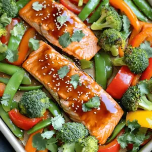 - 4 salmon fillets - 2 tablespoons teriyaki sauce - 1 tablespoon soy sauce - 1 tablespoon honey - 1 tablespoon sesame oil - 1 bell pepper, sliced (any color) - 2 cups broccoli florets - 1 cup snap peas - 1 carrot, thinly sliced - 2 tablespoons sesame seeds (for garnish) - Salt and pepper to taste - Fresh cilantro - Green onions You can swap salmon for chicken or tofu. Both work well with the sauce. If you don't have teriyaki sauce, mix soy sauce with brown sugar. For veggies, use zucchini or asparagus if you like. Don’t have sesame oil? Olive oil is a good choice. Just remember, each swap will slightly change the taste. Adjust to your liking! Start by preheating your oven to 400°F (200°C). This temperature helps cook the salmon and veggies evenly. Next, line a large baking sheet with parchment paper. This makes cleanup easy and keeps the food from sticking. In a small bowl, whisk together the teriyaki sauce, soy sauce, honey, and sesame oil. Mix them well until smooth. This sauce adds a sweet and savory flavor to the dish. Set the bowl aside for now. Place the salmon fillets in the center of your baking sheet. Season them with salt and pepper to taste. Next, arrange the sliced bell peppers, broccoli florets, snap peas, and sliced carrots around the salmon. Make sure to spread the veggies out. Drizzle the teriyaki sauce mixture over the salmon and veggies. Toss the vegetables gently to coat them in the sauce. Bake everything in the oven for about 15-20 minutes. The salmon should flake easily with a fork when done. The veggies will be tender and bright. Once finished, sprinkle sesame seeds and chopped cilantro or green onions on top for a fresh look. To get perfect salmon, start with fresh fillets. Look for bright, shiny skin. It should look moist, not dry. Season the salmon with salt and pepper before cooking. This adds flavor and helps enhance its natural taste. When you bake the salmon, keep an eye on the time. It usually takes 15 to 20 minutes at 400°F. The salmon is done when it flakes easily with a fork. This means it is moist and tender, just how you want it. Choose colorful veggies for a beautiful dish. I like to use bell peppers, broccoli, snap peas, and carrots. Cut the veggies into even pieces for uniform cooking. Slice bell peppers into strips and carrots into thin rounds. Broccoli florets should be bite-sized. This helps them cook at the same rate as the salmon. Toss the veggies with the teriyaki sauce for extra flavor. This also helps them get that nice, glossy look. To cook everything evenly, spread the salmon and veggies out on the baking sheet. Make sure they are not crowded. If they are too close, they will steam instead of roast. Roasting gives a nice, caramelized edge. Rotate the baking sheet halfway through cooking. This ensures even heat and perfect results. If you notice some veggies cooking faster, you can remove them early. Just keep an eye on them to maintain that perfect texture. {{image_2}} You can easily switch the salmon for other proteins. Chicken breasts or thighs work well. They absorb the sauce nicely. Tofu is a great choice for a plant-based meal. It becomes flavorful when marinated. Shrimp is another quick option. Just adjust the cooking time to avoid overcooking. Feel free to mix in other veggies. Asparagus adds a nice crunch. Zucchini slices cook quickly and taste great. Cauliflower florets are a fun option too. You can even toss in baby corn or mushrooms for extra texture. Use whatever veggies you have on hand. This dish is flexible and fun to build upon. You can change the flavor profile easily. Try adding ginger for a spicy kick. A splash of lime juice brightens the dish. Swap teriyaki sauce for hoisin sauce for a twist. You could also add chili paste for heat. Experiment with different spices like garlic powder or onion powder for depth. This way, you'll always enjoy something new! After you enjoy your meal, let the leftovers cool. Place them in an airtight container. You can keep them in the fridge for up to three days. If you plan to eat them later, store them separately. This helps keep the salmon and veggies fresh. To reheat, preheat your oven to 350°F (175°C). Place the salmon and veggies on a baking sheet. Cover them with foil to keep moisture in. Heat for about 10-15 minutes. You can also use a microwave. Use a microwave-safe dish and cover it. Heat in short bursts until warm. If you want to save the dish for later, freezing is a good option. Wrap the salmon and veggies tightly in plastic wrap. Then, place them in a freezer bag. They can last for up to three months in the freezer. When you're ready to eat, move them to the fridge to thaw overnight. Reheat as mentioned above. This keeps the flavors strong and delicious. You should bake salmon and vegetables for about 15 to 20 minutes. The salmon is ready when it flakes easily with a fork. The veggies should be tender yet still bright and crisp. Keep an eye on them, as oven times can vary. Yes, you can use frozen salmon! Just make sure to thaw it first. Place the frozen fillets in the fridge overnight or run them under cold water for about an hour. This helps the salmon cook evenly and taste great. Many sides go well with Teriyaki Salmon and veggies. Some tasty options include: - Steamed rice or jasmine rice - Quinoa for a healthy grain - A fresh green salad with a light dressing - Noodles tossed in sesame oil These sides complement the flavors and add variety to your meal. In this post, I shared a simple way to make sheet-pan teriyaki salmon and veggies. You learned about the key ingredients, step-by-step instructions, and helpful tips. I also covered variations and storage tips to keep your meal fresh. Remember, cooking should be fun and easy. Don’t hesitate to try new ingredients or flavors. Enjoy your cooking journey with this delicious dish!
