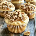 - 1 ½ cups all-purpose flour - ½ cup whole wheat flour - 1 cup brown sugar, packed - 1 tablespoon baking powder - ½ teaspoon baking soda - ½ teaspoon salt - 1 teaspoon ground cinnamon - 2 large eggs - ¾ cup maple syrup - ½ cup buttermilk (or milk) - ⅓ cup unsalted butter, melted - 1 teaspoon vanilla extract - 1 cup walnuts, chopped For the Streusel Topping: - ½ cup all-purpose flour - ½ cup brown sugar, packed - ¼ teaspoon ground cinnamon - ¼ cup unsalted butter, cold and cubed - ½ cup walnuts, chopped (optional) If you need to convert measurements, here are some helpful tips: - 1 cup = 16 tablespoons - ½ cup = 8 tablespoons - 1 tablespoon = 3 teaspoons - 1 teaspoon = 5 milliliters You can use these conversions to adjust your recipe as needed. Feel free to mix things up! Here are some ideas: - Add chocolate chips for extra sweetness. - Use pecans instead of walnuts for a different flavor. - Swap the buttermilk for almond milk for a dairy-free option. - Include dried fruit like cranberries or raisins for added texture. These options let you create a muffin that fits your taste. Enjoy experimenting! Start by preheating your oven to 350°F (175°C). Line a muffin tin with paper liners or grease it lightly. In a large bowl, mix 1 ½ cups all-purpose flour, ½ cup whole wheat flour, 1 cup brown sugar, 1 tablespoon baking powder, ½ teaspoon baking soda, ½ teaspoon salt, and 1 teaspoon ground cinnamon. Whisk everything together until it's well combined. In another bowl, beat 2 large eggs. Then add ¾ cup maple syrup, ½ cup buttermilk, ⅓ cup melted unsalted butter, and 1 teaspoon vanilla extract. Mix these until smooth. Pour the wet mix into the dry mix, and gently stir until just combined. Don’t worry about lumps; they’re okay. Finally, fold in 1 cup of chopped walnuts. For the streusel topping, take a bowl and combine ½ cup all-purpose flour, ½ cup brown sugar, and ¼ teaspoon ground cinnamon. Now, add ¼ cup of cold, cubed unsalted butter. Use your fingers or a pastry cutter to mix until it looks like coarse crumbs. If you want, stir in ½ cup of chopped walnuts for extra crunch. Fill each muffin cup about ¾ full with the batter. Generously sprinkle the streusel topping on each muffin. Bake them in your preheated oven for 18-20 minutes. Check if they’re done by inserting a toothpick in the center; it should come out clean. After baking, let the muffins cool in the pan for 5 minutes. Then, transfer them to a wire rack to cool completely. Enjoy the warm, sweet aroma while waiting! To make bakery-style muffins, use the right ingredients. I suggest using both all-purpose and whole wheat flour. This blend adds texture. Use fresh baking powder for a good rise. Mix wet and dry ingredients separately for the best results. Combine them gently to keep muffins light. Overmixing makes them dense. Fill the muffin cups ¾ full for that perfect dome shape. One common mistake is using too much flour. Always measure flour correctly. Another mistake is overmixing the batter. This can lead to dense muffins. Also, don’t skip the streusel topping. It adds flavor and crunch. Make sure your butter is melted but not hot. Hot butter can cook the eggs, affecting the texture. Lastly, always check your oven’s temperature. An oven that is too hot can dry out your muffins. These muffins taste great warm or at room temperature. For a special touch, drizzle some maple syrup on top. You can also add whole walnuts for crunch. Pair these muffins with coffee or tea for a cozy treat. They are perfect for breakfast or a snack. Store any leftovers in an airtight container. Enjoy them within a few days for the best taste! {{image_2}} You can easily make these muffins gluten-free. Use a gluten-free flour blend instead of all-purpose flour. Look for blends that have xanthan gum for better texture. For a dairy-free option, swap buttermilk with almond milk or coconut milk. Use melted coconut oil instead of butter. This keeps the muffins moist and tasty. Adding chocolate chips gives a rich twist to these muffins. Use semi-sweet or dark chocolate chips to balance the maple flavor. Dried fruits like cranberries or raisins add a sweet and chewy bite. Just fold in about half a cup of chips or fruits to the batter before baking. This makes each muffin even more fun and unique. If you want to change the nuts, pecans work great. They offer a lovely crunch and a slightly sweet flavor. Almonds can be a nice substitute too. Just chop them up and use them in place of walnuts. Both options give the muffins a different taste while keeping them delicious and crunchy. Store your Maple Walnut Streusel Muffins in an airtight container. This keeps them fresh and moist. You can line the container with a paper towel. This helps absorb any extra moisture. If you plan to eat them within a couple of days, leave them at room temperature. For longer storage, refrigerate them. When stored properly, these muffins last about 3 to 5 days at room temperature. If you store them in the fridge, they can last up to 1 week. Always check for any signs of spoilage before eating. If they look or smell off, it’s best to toss them. To freeze your muffins, first let them cool completely. Wrap each muffin in plastic wrap. Then place them in a freezer bag or container. Make sure to squeeze out as much air as possible. They can last up to 3 months in the freezer. When ready to eat, thaw them overnight in the fridge or pop them in the microwave for a quick warm-up. Yes, you can use other sweeteners. Try using coconut sugar or honey. Both can add unique flavors. Just remember, honey is liquid. You may need to adjust the liquid in your recipe. Muffins rise due to a few key factors. Baking powder and baking soda create gas bubbles. This helps the muffin rise. Also, the right mixing technique is vital. Overmixing can lead to dense muffins. Gently fold the wet and dry ingredients together for the best rise. To prevent sinking, avoid overmixing your batter. Overmixing can lead to a weak structure. Also, ensure your ingredients are fresh. Old baking powder or soda may not work well. Lastly, properly fill your muffin cups. Fill them about ¾ full to allow for rise. You learned about muffin making, from ingredients to storing them. You can customize recipes and avoid common mistakes. Remember to follow the steps closely for soft, fluffy muffins. Don’t hesitate to try different flavors and storage tips. Muffins are fun to make and share. With a little care, bakery-style muffins are within your reach. Enjoy your baking journey and share your tasty creations!
