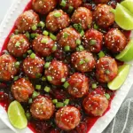 - 1 pound ground turkey or chicken - 1/2 cup breadcrumbs - 1/4 cup grated Parmesan cheese - 1/4 cup chopped fresh parsley - 1 large egg - 1 teaspoon garlic powder - 1 teaspoon onion powder - Salt and pepper to taste To create the meatballs, I start with ground turkey or chicken. This choice keeps them lean but still flavorful. I mix in breadcrumbs to help bind the meatballs. The grated Parmesan cheese gives a rich and savory taste. Fresh parsley adds a pop of color and a hint of freshness. I include a large egg to hold everything together. Then, I season with garlic powder and onion powder for depth. A pinch of salt and pepper rounds out the flavors perfectly. - 1 cup cranberry sauce - 1/2 cup sweet chili sauce - 2 tablespoons soy sauce - 1 tablespoon fresh lime juice - 1 teaspoon grated ginger For the sauce, I use a cup of cranberry sauce. It brings a sweet and tart flavor that pairs well with the meatballs. Sweet chili sauce adds a nice kick of heat. I mix in soy sauce for a savory touch, balancing the sweetness. Fresh lime juice brightens the sauce with acidity. Lastly, I add grated ginger for a warm, spicy note. This sauce coats the meatballs and enhances their flavor as they cook. To make the meatballs, start by mixing the ingredients in a large bowl. You will need: - 1 pound ground turkey or chicken - 1/2 cup breadcrumbs - 1/4 cup grated Parmesan cheese - 1/4 cup chopped fresh parsley - 1 large egg - 1 teaspoon garlic powder - 1 teaspoon onion powder - Salt and pepper to taste Combine all the items until they blend well. I like to use my hands for this. It helps to mix everything evenly. Next, roll the mixture into small meatballs. Aim for about 1 inch in diameter. This size cooks evenly and is perfect for serving. Place the rolled meatballs on a baking sheet. Browning the meatballs is optional but adds great flavor. Heat a skillet over medium heat and add a little oil. Cook the meatballs for 2-3 minutes on each side. This gives them a nice golden color. If you're in a hurry, you can skip this step. The slow cooker will cook them fully. Now it's time to prepare the sauce. In a separate bowl, whisk together the sauce ingredients until smooth. You will need: - 1 cup cranberry sauce - 1/2 cup sweet chili sauce - 2 tablespoons soy sauce - 1 tablespoon fresh lime juice - 1 teaspoon grated ginger Make sure there are no lumps. A smooth sauce coats the meatballs better and tastes great. To cook the meatballs, layer them in the slow cooker. Place the meatballs at the bottom and pour the sauce over them. Make sure each meatball gets coated. Cover the slow cooker and set it to cook. If you are cooking on low, it will take about 4-5 hours. If you prefer high, it will take about 2-3 hours. The meatballs should be cooked through and tender. When done, gently stir the meatballs to coat them again in the sauce before serving. To get the best texture, use ground turkey or chicken. These meats keep the meatballs moist. Mix the meat well with breadcrumbs and cheese. This helps hold them together. Avoid over-mixing, as it can make them tough. Adjust the seasoning to your taste. You can add more garlic or onion powder for extra flavor. A bit of salt and pepper goes a long way. Want to jazz up your meatballs? Try adding chopped onion or bell peppers to the mix. You can also blend in some crushed red pepper for heat. If you prefer a twist, substitute turkey with beef or pork. For a smoky touch, add a dash of smoked paprika. You can also cook these meatballs in an oven. Bake them at 400°F for about 20 minutes. Just make sure they cook all the way through. Presentation matters! Serve your meatballs on a big platter. Garnish them with sliced green onions and sesame seeds. This adds nice color and crunch. Offer toothpicks for easy serving, especially at parties. Pair these meatballs with rice or noodles for a complete meal. A side of steamed veggies works well too. Enjoy the sweet and spicy flavors with a refreshing drink like iced tea or lemonade. {{image_2}} You can change up the protein in your meatballs. Ground beef or pork works well. If you want a healthier option, try ground turkey or chicken. These swaps keep the dish tasty and light. For gluten-free options, use gluten-free breadcrumbs or oats. This way, everyone can enjoy the dish without worry. You can switch the sweeteners in the sauce for a different flavor. Try honey or maple syrup for a unique twist. If you like to make your own sauces, mix cranberry juice with chili sauce and a touch of soy sauce. Homemade sauces can add a fresh taste to the meatballs. You can serve these meatballs as an appetizer or a main dish. For appetizers, use toothpicks for easy eating. They make great finger foods at parties. If you want to serve them as a main dish, pair them with rice or noodles. This makes for a filling and satisfying meal. You can also add steamed veggies on the side for a complete dinner. To keep your meatballs fresh, store them in an airtight container. This will help prevent any odors from other foods. You can refrigerate them right after they cool. They will stay good in the fridge for about 3 to 4 days. You can freeze these meatballs for longer storage. First, let them cool completely. Then, place them in a single layer on a baking sheet. Freeze until firm, about 1 hour. After that, put them in a freezer bag. They can last for up to 3 months in the freezer. When you’re ready to eat, thaw the meatballs in the fridge overnight. You can reheat them in the microwave or on the stove. Just make sure they are heated all the way through. Enjoy their sweet and spicy flavors! To check if the meatballs are cooked, use a meat thermometer. Insert it into the center of a meatball. The temperature should reach 165°F (74°C). If you don't have a thermometer, look for visual cues. The meatballs should be firm to the touch and have no pink in the center. Yes, you can make these meatballs ahead. Mix the meatball ingredients and form them into balls. Store uncooked meatballs in the fridge for up to 24 hours. You can also freeze them for later use. If you want to store cooked meatballs, place them in an airtight container. They last in the fridge for up to four days. These meatballs pair well with various side dishes. Serve them with rice or noodles for a filling meal. You can also enjoy them with a fresh salad for a lighter option. For drinks, consider pairing with iced tea or a light white wine. These options balance the sweet and spicy flavors of the meatballs perfectly. These sweet chili cranberry meatballs blend simple ingredients for a tasty meal. We covered the key components, from the ground turkey to the flavorful sauce. I shared step-by-step instructions for cooking and tips to perfect your meatballs. You can tweak recipes with various proteins and sauces to fit your taste. With proper storage, these meatballs can be enjoyed later. I hope you feel ready to try this dish and impress everyone at the table. Happy cooking!