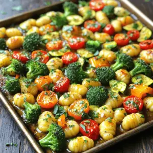 - 1 pound gnocchi (store-bought or homemade) - 2 cups broccoli florets - 1 cup cherry tomatoes, halved - 1 bell pepper, sliced (any color) - 1 medium zucchini, sliced - 4 tablespoons unsalted butter - 5 cloves garlic, minced - 1 teaspoon dried oregano - 1 teaspoon dried thyme - Salt and pepper to taste I love using gnocchi because it cooks fast and tastes amazing. You can use store-bought gnocchi if you’re short on time, but homemade gnocchi adds a special touch. Fresh vegetables like broccoli, cherry tomatoes, bell pepper, and zucchini give color and flavor. The garlic butter mixture is where the magic happens. The butter makes everything rich. Garlic adds a warm and inviting taste. Oregano and thyme bring in great depth. Don't forget to season with salt and pepper for a perfect balance. - 1/4 cup grated Parmesan cheese (for topping) - Fresh parsley, chopped (for garnish) Adding Parmesan cheese on top gives a nice, salty finish. It melts beautifully and makes the dish even richer. Fresh parsley not only looks nice but also adds a burst of fresh flavor. You can skip these if you want a lighter dish, but I find they really elevate the meal. 1. First, preheat your oven to 425°F (220°C). This helps cook everything evenly and gives a nice crisp. 2. Next, grab a large bowl. Add 1 pound of gnocchi, 2 cups of broccoli florets, 1 cup of halved cherry tomatoes, 1 sliced bell pepper, and 1 sliced medium zucchini. Mix them well, so they are ready for the garlic butter. 1. In a small saucepan, melt 4 tablespoons of unsalted butter over medium heat. 2. Once the butter melts, add 5 cloves of minced garlic, 1 teaspoon of dried oregano, 1 teaspoon of dried thyme, salt, and pepper. Stir for about 2-3 minutes until you smell the garlic's nice aroma. 3. Pour this garlic butter mix over the gnocchi and veggie mix. Toss everything together until each piece gets a good coat of that delicious garlic butter. 1. Spread the coated mixture evenly on a large sheet pan. Ensure that everything lies in a single layer. This helps the gnocchi and veggies roast well. 2. Bake in the preheated oven for 20-25 minutes. You want the gnocchi to turn golden and the veggies to get tender. Stir halfway through to keep things cooking evenly. 3. When time is up, take it out of the oven. If you like, sprinkle some grated Parmesan cheese on top. Return it to the oven for another 5 minutes to melt the cheese. 4. Before serving, sprinkle fresh chopped parsley for a lovely finish. Enjoy your meal! To make this dish shine, keep the ingredients in a single layer on the sheet pan. This step helps everything cook evenly, so you get a nice crisp on the gnocchi and veggies. If they are piled up, they may steam instead of roast. To check for doneness, look for golden-brown gnocchi and tender veggies. You should be able to pierce them easily with a fork. Stir the mix halfway through baking for even cooking. When picking vegetables, fresh is often best for flavor and texture. Choose bright broccoli, ripe cherry tomatoes, and firm bell peppers. If fresh veggies aren't available, frozen can work too. Just make sure to thaw and drain them before use. For gnocchi, you can go with store-bought for convenience or make your own if you feel adventurous. Homemade gnocchi adds a personal touch and can be tailored to your taste. To make your dish even more flavorful, consider adding optional spices like red pepper flakes for heat or smoked paprika for depth. Fresh herbs like basil or thyme can brighten the dish as well. A squeeze of lemon juice before serving adds a nice zing, too. Try different toppings like crumbled feta or toasted pine nuts for extra texture. {{image_2}} You can switch up the veggies for this dish. Try using asparagus, carrots, or green beans. They add great color and flavor. Seasonal veggies work best, too. In spring, use peas or snap peas. In fall, consider butternut squash. Each change can give the dish a fresh twist. Adding protein makes this meal heartier. For meat lovers, diced chicken or shrimp fits well. Just cook them in the garlic butter mix first. For a vegetarian option, try chickpeas or white beans. They add protein and work great with the garlic butter. Feel free to play with sauces. A lemon butter sauce brightens the dish. You could also use pesto for a herby punch. If you want a kick, add some red pepper flakes. The options are endless, so have fun experimenting! To store leftovers, let the dish cool down first. Use an airtight container. Place it in the fridge. This keeps the gnocchi and veggies fresh for up to three days. If you want to keep them longer, freezing is an option. When reheating, the goal is to keep the texture great. You can use the oven or a skillet. If using the oven, set it to 350°F (175°C). Place the dish in the oven for about 10-15 minutes, covered with foil. This helps maintain moisture. If using a skillet, add a splash of water and cover it. Heat on medium until hot. Yes, you can freeze this dish! Make sure to use a freezer-safe container. Let the dish cool completely. Then, portion it out and seal tightly. It will last for about two months in the freezer. When ready to eat, thaw in the fridge overnight. Reheat gently for the best results. Yes, you can use homemade gnocchi. Homemade gnocchi often tastes fresher and has a unique texture. If you make your own, ensure they are cooked just right. Boil them until they float before adding to the sheet pan. Store-bought gnocchi is quick and convenient. Both types work well in this dish. Just remember, the cooking times may vary slightly. If you don't like garlic, consider using shallots or leeks. Both add sweet and mild flavors. You can also use garlic powder if fresh garlic is not available. If you're looking for a different twist, try herbs like rosemary or basil. They bring out fresh flavors without the garlic punch. To make this dish dairy-free, swap unsalted butter with olive oil or vegan butter. For cheese, use nutritional yeast for a cheesy flavor. You can also try dairy-free cheese options if you want a melty topping. These swaps maintain flavor while keeping the dish suitable for a dairy-free diet. This recipe combines gnocchi, fresh vegetables, and garlic butter. You learned how to prepare ingredients, bake, and store leftovers. I shared tips on flavor boosts and variations to suit your taste. Remember, you can use different vegetables, proteins, or sauces to make this dish your own. Cooking should be fun, so feel free to experiment. Enjoy creating a delightful meal that brings joy and flavor to your table!