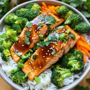 To make the teriyaki salmon rice bowls, you need: - 2 salmon fillets - 1 cup jasmine rice - 2 cups water - 1/4 cup low-sodium soy sauce - 2 tablespoons honey or maple syrup - 1 tablespoon rice vinegar - 1 teaspoon sesame oil - 2 green onions, chopped - 1 tablespoon sesame seeds - 1 cup steamed broccoli florets - 1 carrot, julienned - Salt and pepper to taste - Fresh cilantro for garnish (optional) These ingredients bring bold flavors and great texture. Salmon gives a rich taste. Jasmine rice adds a fragrant base. The soy sauce and honey blend for a sweet and salty sauce. This recipe uses quick-cook ingredients. The jasmine rice cooks in about 15-18 minutes. Salmon cooks fast in a skillet. You can prepare the teriyaki sauce in just a few minutes. This means you can enjoy this meal in about 30 minutes! For garnishes, I recommend using chopped green onions and sesame seeds. They add crunch and flavor. Fresh cilantro can also brighten your dish. If you want more veggies, add bell peppers or snap peas. These choices make your bowl colorful and tasty! To start, rinse 1 cup of jasmine rice under cold water. Keep rinsing until the water runs clear. This step helps remove extra starch. Next, add the rinsed rice to a saucepan with 2 cups of water. Bring this mixture to a boil. Once it boils, lower the heat to low. Cover the saucepan and let it simmer for 15 to 18 minutes. When all the water is gone, fluff the rice with a fork and set it aside. Making teriyaki sauce is easy and quick. In a small bowl, mix together 1/4 cup of low-sodium soy sauce, 2 tablespoons of honey or maple syrup, 1 tablespoon of rice vinegar, and 1 teaspoon of sesame oil. Whisk these ingredients until well combined. This sauce adds a sweet and savory flavor to the salmon. Set the sauce aside for later. For the salmon, use 2 fillets. Heat a non-stick skillet over medium heat. Season the salmon with salt and pepper. Once the skillet is hot, place the fillets skin-side down. Cook them for about 4 to 5 minutes. Flip the fillets, then pour the teriyaki sauce over them. Cook for another 3 to 4 minutes. Baste the salmon with the sauce to keep it moist. The salmon is done when it flakes easily with a fork. To cook salmon well, start with fresh, high-quality fillets. Make sure they are thawed if frozen. Season them with salt and pepper just before cooking. Heat your skillet on medium. Use a non-stick pan to prevent sticking. Cook the salmon skin-side down first. This gives it a nice texture. Watch for the edges to turn pink. Flip the fillets gently when they are ready. Pour the teriyaki sauce over the salmon to add flavor. Cook until the fish flakes easily. This should take about 7-9 minutes total. You can add more flavor to your teriyaki salmon in simple ways. Try ginger or garlic for a zesty kick. A sprinkle of red pepper flakes adds heat. For a fresh touch, squeeze some lime juice over the top. You can also mix in a little orange zest in the teriyaki sauce. This gives a sweet and citrusy twist. Experiment with these extras to find your favorite blend. Sometimes cooking salmon can be tricky. If the fish sticks to the pan, it may not be hot enough. Make sure to preheat your skillet well. If your salmon is overcooked, it will be dry. Keep a close eye on the cooking time. If you notice your teriyaki sauce is too thick, add a splash of water to thin it out. If the flavor is too salty, adding a bit of honey can balance it. Remember, practice makes perfect! {{image_2}} If you want a change from salmon, try different proteins. Chicken works great here. Just grill or pan-sear it until cooked. Shrimp is another fast option. Sauté shrimp in the teriyaki sauce for a quick meal. Tofu can also be used for a vegetarian twist. Press and cube the tofu, then fry until golden. This gives you great texture and flavor. For a vegan rice bowl, swap the salmon for tempeh or more tofu. Use the same teriyaki sauce on these proteins. Instead of honey, use maple syrup to keep it vegan. You can add more veggies like bell peppers or snap peas. They add color and crunch. This way, you still enjoy a hearty bowl without animal products. Don’t be afraid to get creative with your rice bowls. You can serve them in a lettuce wrap for a fresh twist. Use large lettuce leaves to hold the rice and toppings. Try adding pickled ginger for a zesty kick. Crispy nori strips can also add great flavor. You can mix and match your favorite toppings for a unique meal each time. To store leftover salmon rice bowls, let them cool first. Place them in an airtight container. Make sure to separate the salmon, rice, and veggies if you can. This keeps the texture nice. Store in the fridge for up to three days. For best taste, eat them sooner rather than later. When you are ready to eat, take the salmon rice bowl from the fridge. If you stored the ingredients separately, combine them back together. Place the bowl in the microwave. Heat it in short bursts, about 30 seconds at a time. Stir between each burst to ensure even heating. You can also reheat it on the stove. Just use medium heat until warm. Add a splash of water for steam. This keeps the rice moist. If you want to freeze your salmon rice bowls, pack them in freezer-safe containers. Allow the bowls to cool before sealing. You can freeze them for up to three months. When you’re ready to eat, thaw them in the fridge overnight. Reheat them in the microwave or on the stove as mentioned earlier. This way, you have a quick meal ready when you need it! Yes, you can use brown rice. Brown rice has more fiber and nutrients. It takes longer to cook, about 40-50 minutes. You may need more water too, so adjust your cooking time and liquid. The taste is nuttier, which adds a nice twist to your bowl. Cooked salmon lasts 3 to 4 days in the fridge. Store it in an airtight container. Always check for any off smells or changes in texture before eating. If it looks or smells bad, it's better to toss it out for safety. You can use coconut aminos as a soy sauce alternative. It’s lower in sodium and has a mild taste. If you need a gluten-free option, look for tamari sauce. For a lighter flavor, try a mix of broth with a bit of vinegar. In this article, we explored how to make Teriyaki Salmon Rice Bowls. We discussed essential ingredients, quick-cook options, and suggested garnishes. I shared steps for cooking jasmine rice, making teriyaki sauce, and perfectly cooking salmon. You learned tips for enhancing flavors and fixing common issues. We also covered tasty variations and storage methods. Now, you have all the tools to create a delicious meal. Enjoy your cooking and get creative with it!