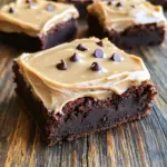 - 1 cup unsalted butter - 2 cups granulated sugar - 4 large eggs - 1 teaspoon vanilla extract - 1 cup all-purpose flour - 1 cup unsweetened cocoa powder - 1 teaspoon baking powder - 1/2 teaspoon salt - 1/4 cup strong brewed coffee (cooled) - 1 cup semi-sweet chocolate chips - 1/2 cup unsalted butter, softened - 2 cups powdered sugar - 1/4 cup brewed coffee (cooled) - 2 tablespoons cocoa powder - 1/2 teaspoon vanilla extract When I create these frosted coffee brownies, I gather my ingredients first. This makes the process smooth and fun. The main star is unsalted butter, which adds richness. Granulated sugar gives sweetness that balances the bitter coffee. I use four large eggs for a moist texture. The vanilla extract brings warmth and depth to the flavor. I always choose all-purpose flour and unsweetened cocoa powder for that perfect brownie base. Baking powder helps the brownies rise just right, while salt enhances all the flavors. Brewed coffee is a key ingredient. It adds a lovely coffee flavor and pairs well with the chocolate. I toss in semi-sweet chocolate chips for extra indulgence. For the frosting, I whip up softened unsalted butter until creamy. Powdered sugar gives it the right sweetness and texture. The cooled brewed coffee adds flavor and moisture, while cocoa powder deepens the chocolate taste. Finally, I mix in a hint of vanilla extract to tie it all together. This combination of ingredients is pure magic! First, preheat your oven to 350°F (175°C). Grease a 9x13-inch baking pan to prevent sticking. Next, melt 1 cup of unsalted butter in a medium saucepan over low heat. Once it’s melted, take it off the heat. Stir in 2 cups of granulated sugar until it’s mixed well. Now, add 4 large eggs one at a time. Mix after each egg to blend them smoothly. Finally, stir in 1 teaspoon of vanilla extract for flavor. In a separate bowl, sift together 1 cup of all-purpose flour, 1 cup of unsweetened cocoa powder, 1 teaspoon of baking powder, and 1/2 teaspoon of salt. This step adds air and helps the brownies rise. Gradually mix these dry ingredients into the wet mixture. Stir gently until just combined. Now, pour in 1/4 cup of cooled brewed coffee and fold in 1 cup of semi-sweet chocolate chips. This gives the brownies a rich flavor. Spread the batter evenly in the prepared pan. Bake for 25-30 minutes. Check for doneness by inserting a toothpick in the center; it should come out with a few moist crumbs. Allow the brownies to cool completely in the pan before frosting them. Oven temperature matters. Preheat to 350°F (175°C) for even baking. Use an oven thermometer if needed. This ensures your brownies bake just right. To check if brownies are done, insert a toothpick in the center. If it comes out with a few moist crumbs, they are ready. Overbaking can lead to dry brownies, so keep an eye on them. For fluffy frosting, start with softened butter. Beat it well until creamy. This helps incorporate air and adds lightness. Next, add powdered sugar slowly. Mix thoroughly to avoid clumps. Adjust sweetness to your taste. If you want a stronger coffee flavor, add more cooled coffee. You can also include a little cocoa powder for extra depth. Slice brownies into squares while they are still in the pan. Use a sharp knife for clean cuts. Wipe the knife with a damp cloth between slices for neat edges. Pair these brownies with a scoop of vanilla ice cream or a dollop of whipped cream. The creaminess balances the rich coffee flavor perfectly. You can also sprinkle some chocolate shavings on top for a fun touch. {{image_2}} You can make your brownies even more exciting with mix-ins. Here are some ideas: - Nuts: Add walnuts or pecans for a crunch. They blend well with the soft brownie. - Chocolate chips: Use dark or white chocolate chips. Each type adds a new flavor twist. Frosting can change the whole taste. Try these alternatives: - Cream cheese frosting: This adds a rich and tangy flavor. It pairs well with coffee. - Ganache topping: Melt chocolate with cream for a smooth finish. This gives a luxurious texture. You can also make these brownies fit special diets. Here’s how: - Gluten-free: Use gluten-free flour alternatives like almond or oat flour. These work well in brownies. - Vegan: Substitute eggs with flaxseed or applesauce. For butter, try coconut oil or vegan butter. These swaps keep the taste delicious. You can keep your frosted coffee brownies at room temperature for a few days. Use an airtight container to keep them fresh. If you want to store them longer, refrigeration works too. Just make sure to wrap them well to avoid drying out. To freeze brownies, cut them into squares first. Place them in a single layer on a baking sheet. Freeze them for about an hour until firm. Then, transfer the squares into an airtight container or a freezer bag. Be sure to label and date the bag. For thawing, take them out and let them sit at room temperature for about 30 minutes. This keeps them soft and tasty. Enjoy your brownies any time! To keep your brownies fresh, store them in an airtight container. Place them at room temperature. This helps maintain their soft texture and rich flavor. If you prefer, you can refrigerate them. Just be aware that cold storage can slightly change their texture. For best results, let them sit at room temperature for a bit before serving. Yes! You can change the coffee flavor to fit your taste. If you want a stronger coffee taste, use a darker brew. For a milder flavor, choose a lighter roast. You can also add coffee extract for extra intensity. Just remember to adjust the amount to avoid overpowering the brownies. Reheating brownies can bring back their warm, gooey goodness. The best method is to use a microwave. Place a brownie on a microwave-safe plate. Heat it for about 10-15 seconds. Check if it’s warm enough. If not, heat for another 5 seconds. You can also use an oven. Preheat it to 350°F (175°C) and bake for about 5-10 minutes. This method helps keep the top crisp while warming the inside. In this post, we explored how to make delicious coffee brownies, from ingredients to storage tips. You learned to mix butter, sugar, eggs, and coffee for batter. We discussed frosting options and ways to customize your treats. Remember, perfect brownies need the right baking time and temperature. Don’t forget to enjoy them with ice cream! With these steps, you’ll create tasty brownies every time. Happy baking and enjoy every bite of your creation!