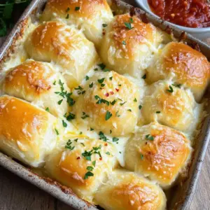 - 1 cup warm milk (110°F) - 2 tablespoons sugar - 2 1/4 teaspoons active dry yeast (1 packet) - 3 cups all-purpose flour - 1/2 teaspoon salt - 1/4 cup unsalted butter, melted - 1 cup shredded mozzarella cheese - 1/2 cup grated Parmesan cheese - 4 cloves garlic, minced - 2 tablespoons fresh parsley, chopped - 1/4 teaspoon red pepper flakes (optional) To make cheesy garlic rolls, you need a few key ingredients. First, warm milk helps activate the yeast. Sugar feeds the yeast, making it frothy. The yeast is the magic that makes the rolls rise. Next, all-purpose flour and salt form the base of the dough. The flour gives the rolls their structure, while salt balances the flavors. Then, for flavor, you have unsalted butter, mozzarella cheese, and Parmesan cheese. The butter adds richness, while the cheese brings gooey, melty goodness. Garlic, fresh parsley, and optional red pepper flakes add depth and warmth. Garlic gives a strong, savory taste, and parsley adds freshness. Red pepper flakes can spice things up if you like heat. Gather these ingredients, and you’re ready to create some delightful rolls! First, you need to wake up the yeast. In a small bowl, mix together the warm milk, sugar, and active dry yeast. Make sure the milk is warm, around 110°F. This warmth helps the yeast activate. Let this mixture sit for about 5 to 10 minutes. You will know it's ready when it gets frothy on top. This froth shows that the yeast is alive and ready to work. Next, grab a large mixing bowl. Combine the all-purpose flour and salt in this bowl. Make a well in the center of the flour. Pour in the melted butter, the egg, and the frothy yeast mixture. Mix it all together until a dough starts to form. The dough will feel a bit sticky at first, but that’s okay. Now, it’s time to knead the dough. Turn it out onto a floured surface. Knead it for about 5 to 7 minutes. You want it to feel smooth and elastic. Once kneaded, place the dough in a lightly greased bowl. Cover it with a cloth and let it rise in a warm spot. Wait about 1 hour or until it doubles in size. This step is important for soft rolls. After the dough has risen, punch it down gently. Then roll it out into a rectangle, about 1/4 inch thick. Now, for the fun part! Spread a mixture of mozzarella cheese, Parmesan cheese, minced garlic, and chopped parsley over the dough. If you like a little heat, add some red pepper flakes. Roll the dough tightly from the long edge to form a log. Cut this log into 12 equal pieces. Place these pieces in a greased baking dish. Preheat your oven to 375°F (190°C). While it heats, let the rolls rise again for about 30 minutes. This second rise helps them get fluffy. Once ready, bake the rolls in the preheated oven for 20 to 25 minutes. They should be golden brown on top. When they finish baking, brush them with melted butter for extra flavor. Sprinkle with more herbs if you like. Enjoy your cheesy garlic rolls warm! To make your cheesy garlic rolls soft and fluffy, kneading is key. Knead the dough for 5-7 minutes. This helps build gluten, which gives the rolls their nice texture. If the dough feels too sticky, add a little flour. If it feels too dry, wet your hands and knead again. The right rising conditions also matter. Place the dough in a warm area. You can use your oven with the light on. Cover the bowl with a cloth to keep it warm and moist. It should double in size in about an hour. You can spice up your rolls with herbs or spices. Try adding a teaspoon of dried oregano or basil to the dough. For a kick, add a pinch more red pepper flakes. Cheese options are fun too! While mozzarella and Parmesan are great, you can mix in cheddar or gouda. Each cheese adds a unique flavor. Experiment to find your favorite combo! These rolls shine with dips and sides. Serve them warm with marinara sauce or garlic butter. A fresh salad pairs well too. For presentation, arrange the rolls in a circle on a plate. Sprinkle extra parsley on top for color. You can also place a small bowl of sauce in the center for easy dipping. This makes your dish look inviting and fun! {{image_2}} You can use different cheeses for Cheesy Garlic Rolls. Mozzarella and Parmesan make a great combo. Try adding cheddar for a sharper taste. Gouda offers a smoky flavor. If you want something more unique, feta or blue cheese can add a fun twist. Mixing cheeses creates a rich, melty experience that everyone will love. Incorporating meats or veggies can enhance your rolls. Try adding cooked bacon or ham for a savory kick. Spinach or mushrooms add a healthy touch. You can even mix in roasted red peppers for a pop of color and flavor. Just chop your extras finely before adding them to the cheese mixture. This makes sure every bite is packed with taste. You can enjoy these rolls gluten-free! Use gluten-free flour instead of all-purpose flour. Make sure to check for a good blend that works for bread. Follow the same steps in the recipe. The texture might be a bit different, but the flavors will shine through. You won’t miss out on the cheesy goodness. To keep your cheesy garlic rolls fresh, place them in an airtight container. This will help prevent them from drying out. You can also wrap them in plastic wrap. Store them in the fridge for up to three days. If you want them to last longer, freezing is a great option. To freeze your cheesy garlic rolls, let them cool completely first. Then, wrap each roll tightly in plastic wrap. Place the wrapped rolls in a freezer-safe bag or container. This way, they can stay fresh for up to three months. When you’re ready to eat, just take out the number you need. To reheat, you have a few options. The best method is the oven. Preheat the oven to 350°F (175°C). Place the rolls on a baking sheet and cover them with foil. Heat for about 10-15 minutes. If you’re in a hurry, you can use the microwave. Heat each roll for 20-30 seconds. Just be careful not to dry them out! Enjoy them warm for the best taste. Yes, you can make the dough ahead of time. This helps save time later. - Prepare the dough as directed. - After kneading, cover it with plastic wrap. - Place it in the fridge for up to 24 hours. - When ready, let it warm up before shaping. This method helps develop flavor and makes the rolls even better. You can make cheesy garlic rolls without yeast by using baking powder instead. - Replace yeast with 1 tablespoon of baking powder. - Mix it with the dry ingredients. - Skip the rising time since baking powder acts quickly. These rolls will be fluffy and tasty, even without yeast. Cheesy garlic rolls pair well with many dishes and sauces. - Serve them with marinara sauce for dipping. - Try them alongside a fresh salad. - They are great with soups or pasta dishes. These options enhance the meal and make it more enjoyable. Making cheesy garlic rolls is a fun and easy process. We covered the key ingredients, from warm milk to flavorful cheeses. The step-by-step guide took you from activating yeast to baking the rolls. We shared tips for texture and variations to make your rolls unique. Finally, we discussed how to store and reheat leftovers for later. Enjoy creating your perfect cheesy garlic rolls! Use your favorite flavors or share them with friends. Happy baking!